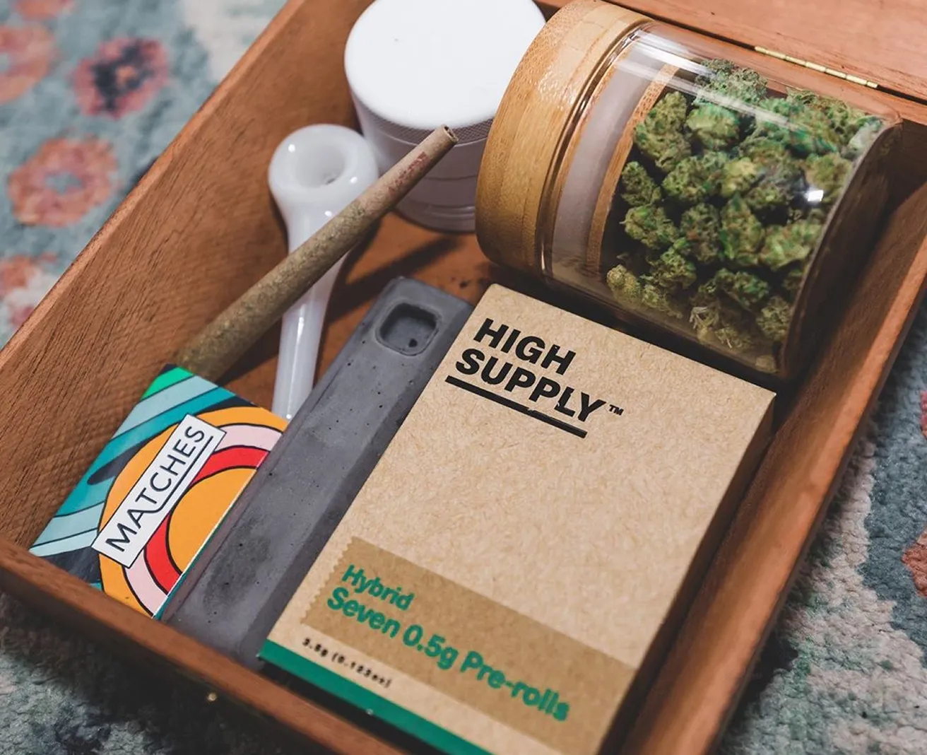 High Supply pre-rolls and flower jar in a wooden tray
