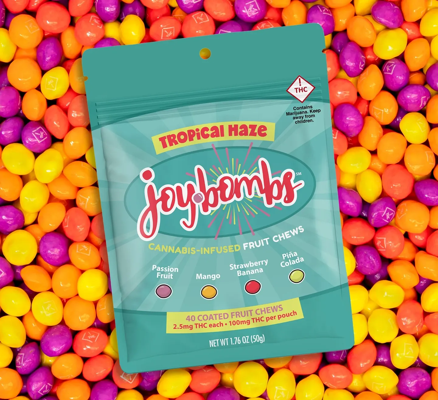 Joy Bombs Tropical Haze pouch on a bed of candy-coated fruit chews