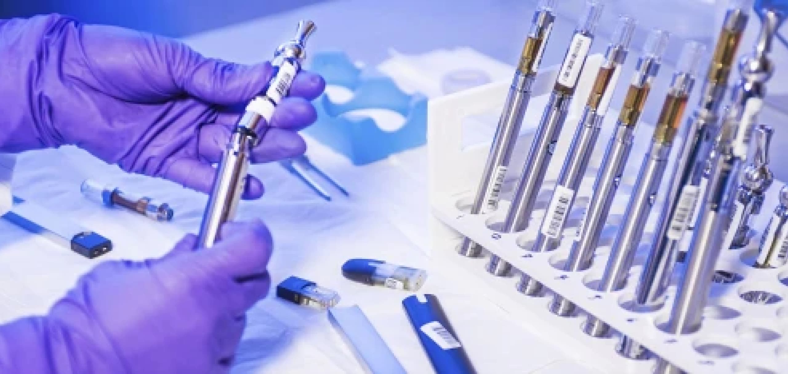 A tray of vape pen cartridges being assembled