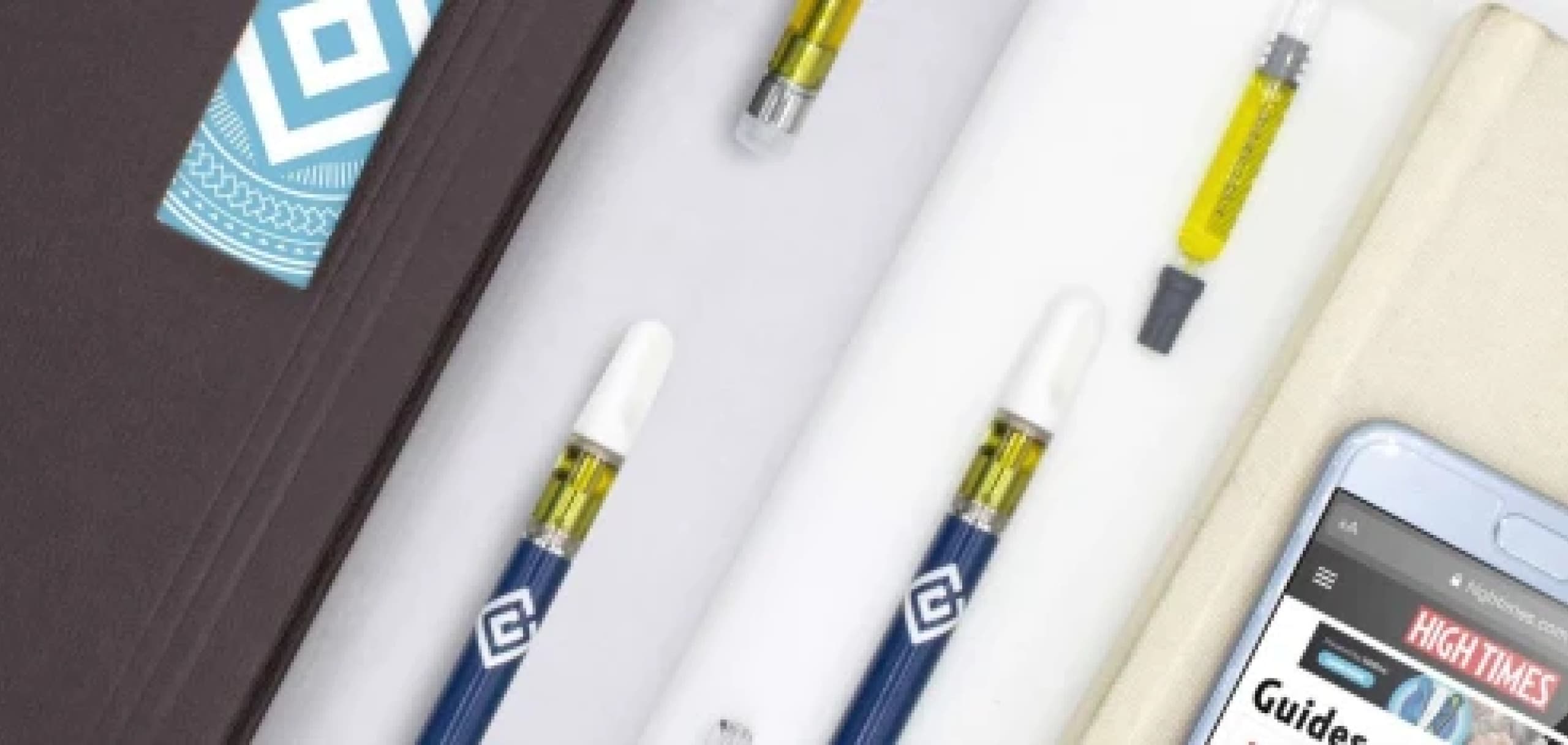 Vape cartridges laid out on a dark surface