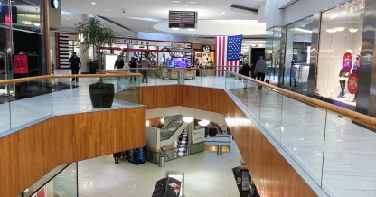 Interior of Holyoke Mall showcasing stores and walkways, suggesting retail and leisure activities as a way to pass time.